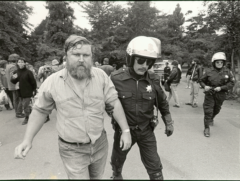 black and white photo of police arresting man