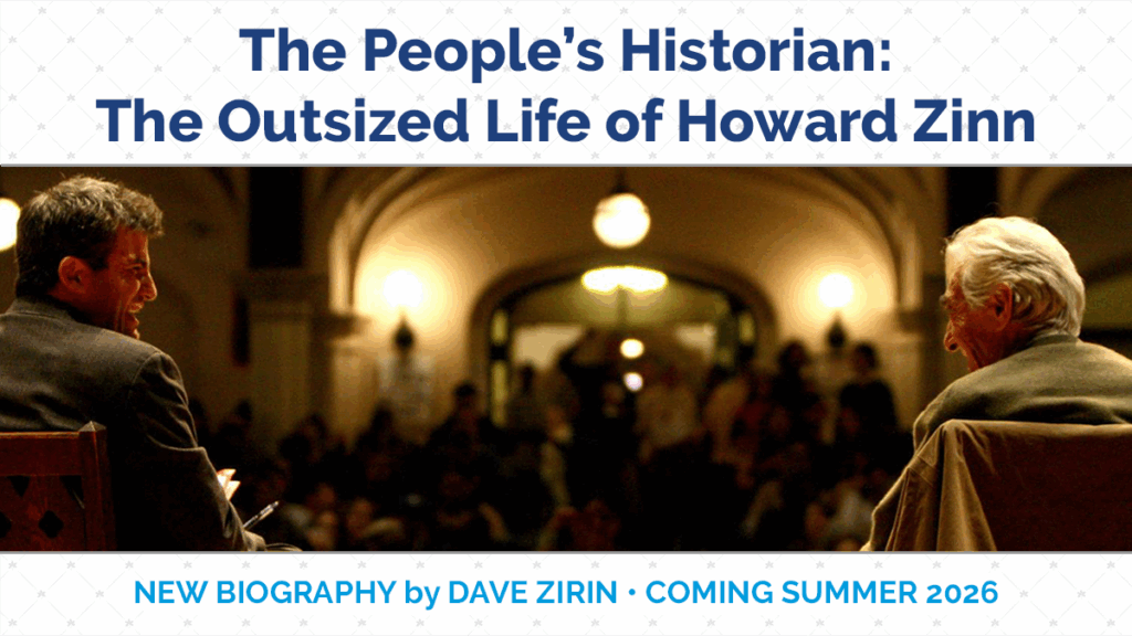 Image of two people sitting on stage, side by side in a presentation hall.