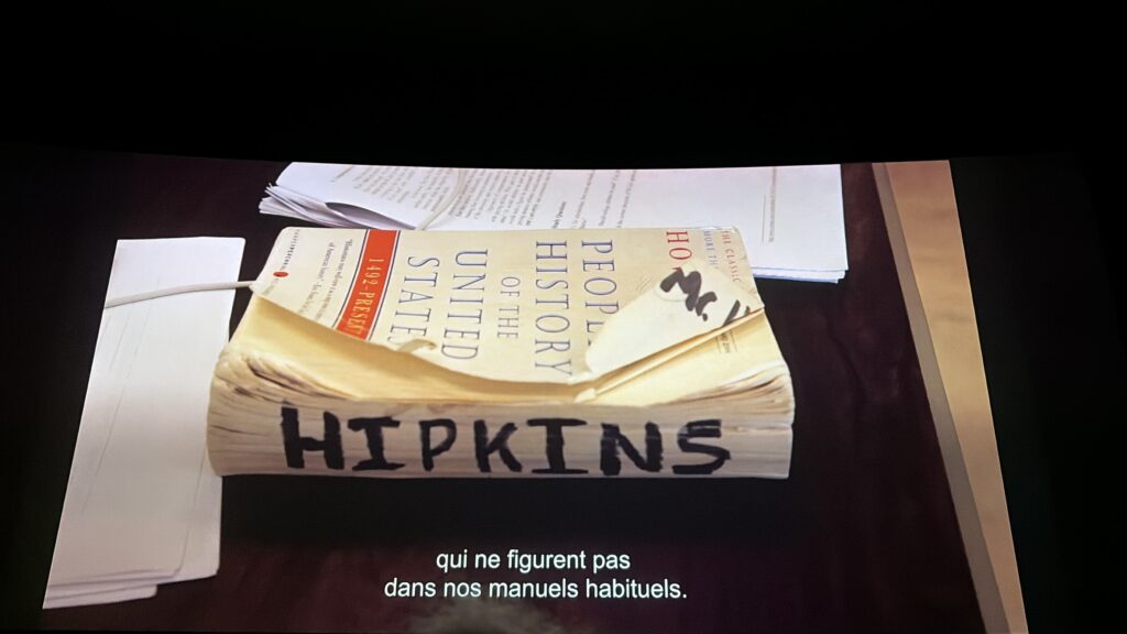 Worn book on table with name written in black marker on side